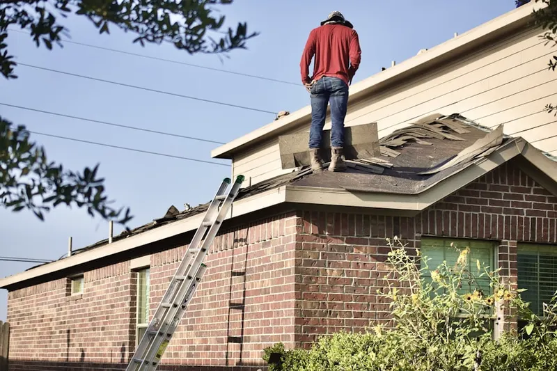 Professional roofer working on a residential roof in Brawley